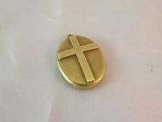 A 15 carat gold locket of oval form decorated with a cross CONDITION REPORTS Overall with general