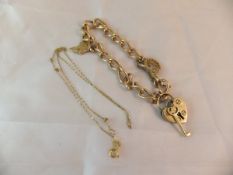 A 9ct gold bracelet with a heart shaped lock and various charms and a 9ct gold necklace CONDITION