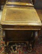 A Victorian walnut Davenport desk, the top with lidded stationery compartment over a sloping writing