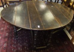 An oak plank topped gateleg dining table on turned supports united by stretchers CONDITION REPORTS