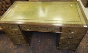 A mahogany pedestal desk of nine drawers