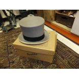 A grey top hat by Scott & Co, housed in