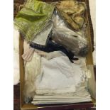 A box containing various textiles to inc