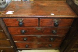 A Victorian stained pine chest of two short and three long graduated drawers, on turned feet, with