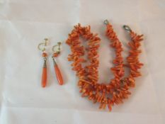 A pair of coral drop earrings and a cora