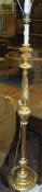 A gilt effect turned and carved lamp sta