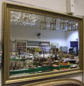 A modern swept gilt framed mirror with b