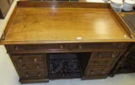 A mahogany pedestal desk of eight drawer