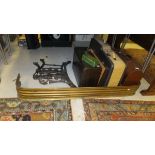A Victorian brass fire kerb, a pair of cast metal bench ends, two portable typewriters,
