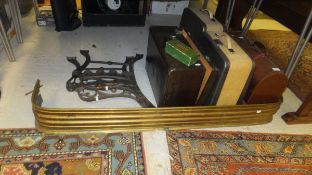 A Victorian brass fire kerb, a pair of cast metal bench ends, two portable typewriters,