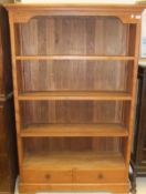 A modern teak open bookcase with three s