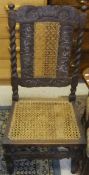 A carved oak hall chair with caned seat