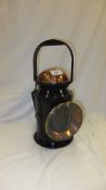 A copper and black painted railway lamp,