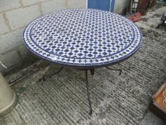 A circular tile effect top garden table