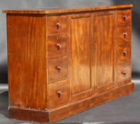 A Victorian mahogany dwarf linen press, the central cupboard doors enclosing linen shelves flanked