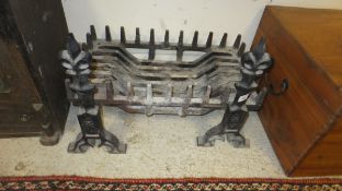 A cast iron fire basket and pair of cast