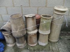 Seven assorted chimney pots and five chimney fittings