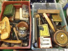 A basket and crate of sundry treen ware including rulers, shoe trees, draughts pieces, walnut