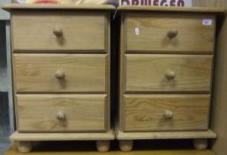 A pair of modern pine three drawer bedsi