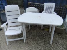 A white plastic garden furniture set com
