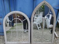 A small arched outdoor mirror, together