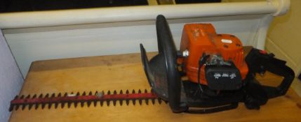 A petrol Flymo hedge trimmer, together w