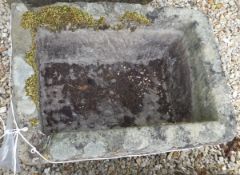 A natural stone rectangular trough