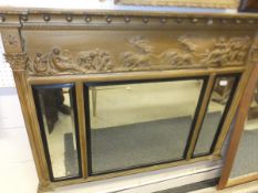 A 19th Century giltwood and gesso framed overmantel mirror in the Regency taste, the three
