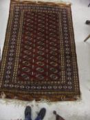 A Bokhara rug, the red centre field with