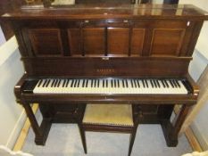 An early 20th Century rosewood cased upright piano, the iron framed overstrung movement by Rogers of