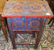 An Indian painted two door cupboard on s