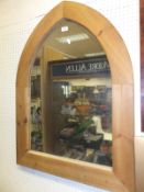 A modern pine Gothic arch framed mirror