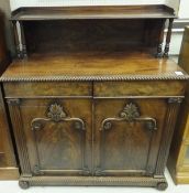 An early Victorian mahogany chiffonier, the raised shelved back on twin turned pillar supports,