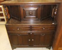 A 1950's oak court cupboard with raised