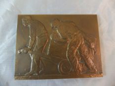 A bronze plaque depicting two workmen, signed "W Burgerez" and stamped "Bronze" to side,