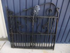 A pair of iron double sized driveway gates with scroll decoration, together with posts,