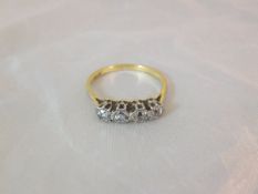 A four stone diamond and 18 carat gold dress ring CONDITION REPORTS Overall with wear, scuffs and
