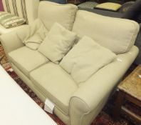 A small modern scroll arm two seat sofa upholstered in taupe fabric