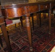 A 19th Century mahogany fold-over tea table on turned and ringed supports