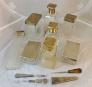 A collection of eight silver mounted Art Deco dressing table bottles with engine turned decoration