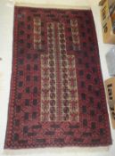A Caucasian prayer rug, the centre mushroom field with repeating motifs in red,