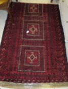 A Caucasian rug, the three central rectangular medallions in red, cream and black within red,