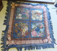 A woolwork stitched rug / throw, each of the four square central panels decorated with flowers on