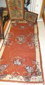 An oriental style rug in shades of terracotta and cream, 180 x 95cm,