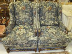 A pair of modern oak framed wing back chairs with turned and ringed supports (for re-upholstery)