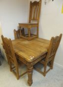 A pine square table with single drawer and carved floral roundels above turned and fluted legs,