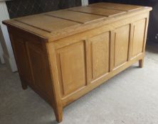 A Cotswold School style oak coffer, the four panel top above a four panel front on chamfered style