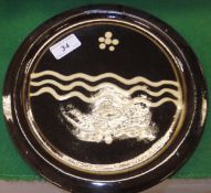 A Michael Cardew slipware plate CONDITION REPORTS Approx 24cm diameter.  Some wear, scuffs and