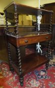 A Victorian mahogany three tier whatnot with three quarter brass gallery top on barley-twist