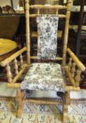 An American style child's rocking chair with tapestry upholstered seat and back